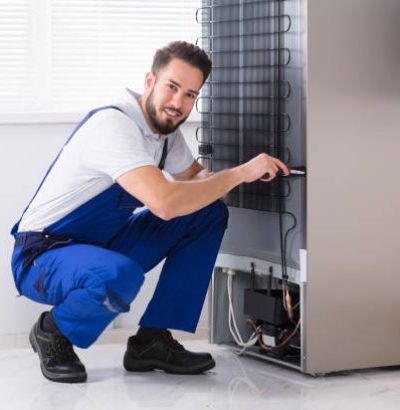 Photo Of Male Technician Fixing Refrigerator In Kitchen